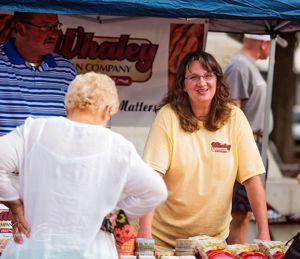 Melissa working a canopy booth to sell pecans